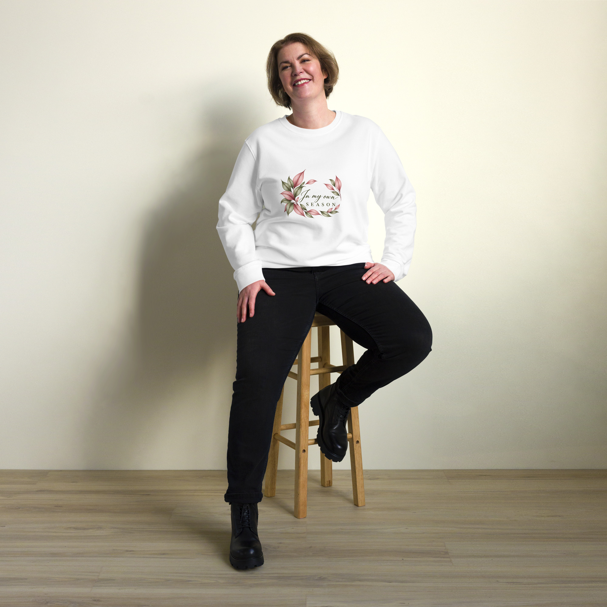 In My Own Season organic crewneck sweatshirt in white with a rose and sage botanical wreath, front view